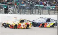  ?? Colin E. Braley / Associated Press ?? Kyle Busch (18) drives in front of Alex Bowman (88) at Kansas Speedway in Kansas City, Kan., Saturday.