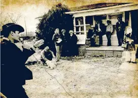  ??  ?? [OKLAHOMAN ARCHIVES PHOTOS] Bob Currey, auctioneer, takes bids from people seeking to buy one of the few remaining houses in the Glenwood addition of Midwest City, as seen in this photo from March 1977.