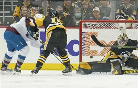  ?? Matt Freed/Post-Gazette ?? A shot by Avalanche center Nathan MacKinnon gets by Tristan Jarry in the first period Tuesday night at PPG Paints Arena. Jarry’s numbers are down slightly since the All-Star break, though part of that is attributab­le to the play in front of him.