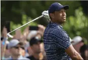  ?? ERIC GAY — THE ASSOCIATED PRESS ?? Tiger Woods watches his shot on the 15th hole during the first round of the PGA Championsh­ip on Thursday.