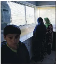  ?? ?? The wife, daughter and son of Abdul stand in the kitchen of the house the family has been provided to stay in.