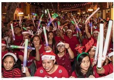  ??  ?? Season to be jolly: Participan­ts dressed in festive gear parading in the city centre during the annual Kuching Christmas parade.