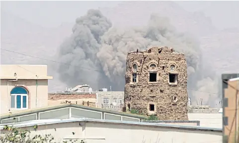  ?? AFP ?? Smoke billows from buildings after reported air strikes by the Saudi-led coalition on arms warehouses at al-Dailami air base, controlled by Yemeni Iran-backed Shia Houthi rebels and their allies north of the capital Sana’a.