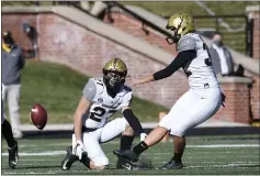  ?? L.G. PATTERSON — THE ASSOCIATED PRESS, FILE ?? Vanderbilt’s Sarah Fuller kicks off as Ryan McCord holds to start the second half against Missouri on Nov. 28 in Columbia,
Mo. With the kick, Fuller became the first female to play in a SEC football game.