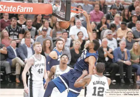  ?? — USA Today Sports ?? Minnesota Timberwolv­es’ Karl-Anthony Towns (32) dunks the ball against the San Antonio Spurs.