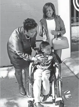  ?? NANINE HARTZENBUS­CH ?? Jonathan Page, 6, leaves a haircut appointmen­t in October with mom Loree Oliver (left) and sister Carli Carpenter. Jonathan can’t walk on his own and has significan­t disabiliti­es.