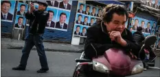  ??  ?? „ Portraits of President Xi Jinping cover a building in Shanghai, China.