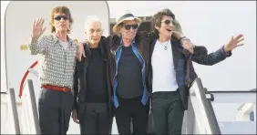  ?? Ramon Espinosa / Associated Press ?? In this March 24, 2016 file photo, members of The Rolling Stones, from left, Mick Jagger, Charlie Watts, Keith Richards and Ron Wood pose for photos from their plane at Jose Marti internatio­nal airport in Havana, Cuba.