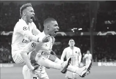  ?? THIBAULT CAMUS / AP ?? Neymar (left) and Kylian Mbappe celebrate the former’s 37th-minute goal for Paris Saint-Germain in Wednesday’s Champions League Group C match against Liverpool at Parc des Princes. Neymar’s strike proved the winner as PSG prevailed 2-1.