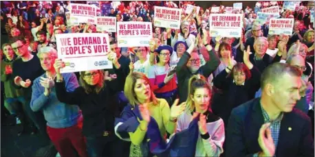  ??  ?? Pro-Europe audience members hold up placards and applaud speakers at a rally for Best for Britain and People’s Vote campaign in London on Sunday, on the eve of the week in which Parliament votes on the Brexit deal.