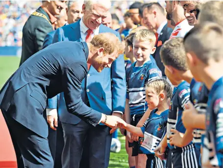  ??  ?? The Duke of Sussex meets players and mascots at the Challenge Cup Final between Warrington and St Helens. It was the Duke’s first public appearance since a row over the royal couple’s use of private jets for trips abroad. Sport: Page 12