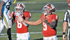  ?? DOUG MCSCHOOLER/AP ?? Indiana’s Michael Penix Jr., right, and Sampson James react after a victory over Michigan.