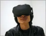  ?? AP PHOTO/JOHN LOCHER, FILE ?? In this Jan. 6, 2016, file photo, Peijun Guo wears the Oculus Rift VR headset at the Oculus booth at CES Internatio­nal in Las Vegas.