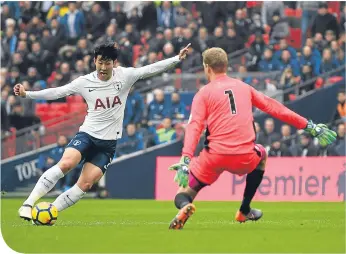  ??  ?? Tottenham’s Son Heung-min beats Town goalkeeper Jonas Lossl to score the opener