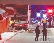  ?? CP PHOTO ?? Police and a first responders work at the scene where a double-decker city bus struck a transit shelter in Ottawa, on Friday.