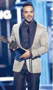  ?? —AFP photos ?? Luis Fonsi receives the Top Hot 100 Song award for Despacito