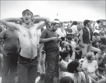  ?? ASSOCIATED PRESS FILE PHOTO ?? Music fans relax during a break in the entertainm­ent at the Woodstock Music and Arts Fair, Aug. 16, 1969, in Bethel, N.Y.