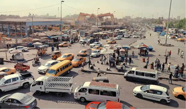  ?? ?? A busy intersecti­on in Baghdad. In a city where summer temperatur­es have reached up to 125 degrees Fahrenheit, the heat and increased air pollution pose particular hazards for the poor. (Emily Garthwaite/the New York Times)