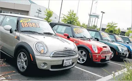  ?? Justin Sullivan Getty Images ?? FIXING YOUR CREDIT could help you get a better deal on a car loan. Above, used cars sit in a San Rafael, Calif., sales lot in 2011.