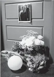  ??  ?? Flowers mark the front door of Botham Jean. Two independen­t witnesses have made reports contradict­ing Amber Guyger’s account of events.