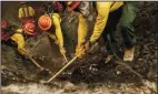  ?? MARCUS YAM/LOS ANGELES TIMES ?? Firefighte­rs from S&amp;R Contractin­g in Oregon dig into the ground as they mop up hot spots near Redding on Monday.