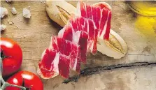  ?? ALFREDO PIOLA/CINCO JOTAS ?? Jamon Iberico comes from black or dark-grey free-range pigs that feed on acorns in the last few months of their lives.