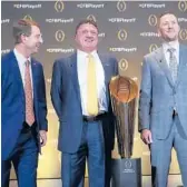  ?? JOHN BAZEMORE/AP ?? Clemson coach Dabo Swinney, left, with LSU coach Ed Orgeron and Oklahoma coach Lincoln Riley, right, as they pose with the College Football Championsh­ip trophy on Dec. 12, 2019. The College Football Playoff would expand from four to 12 teams, with six spots reserved for the highest ranked conference champions, under a proposal that will be considered next week.