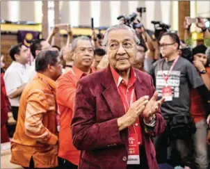  ?? MOHD RASFAN/AFP ?? Former Malaysian Prime Minister Mahathir Mohamad applauds after he was elected as the opposition’s prime ministeria­l candidate in Shah Alam, outside Kuala Lumpur, on Sunday.