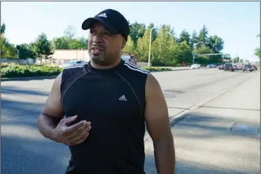  ?? (AP/Ted S. Warren) ?? Dominique Davis, founder of Community Passageway­s, an organizati­on that seeks to prevent community violence, speaks July 12 on Pacific Highway South in Kent, Wash., south of Seattle. The roadway has had multiple problems with shootings and other crimes for many years, Davis said.