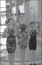  ?? Submitted photo ?? TOP SWIMMERS: The Hot Springs Family YMCA Seals swam to the top at the Go Pink Benton swim meet last month at the Benton Aquatic Center. Audrey Simons, left, led the 9–10 year old girls division for the team, Emma Crowe, center, was the high point winner for the 11–12 year old girls and Aubrey Schmitt, right, won six events to claim the high point award for the 8-and-under girls.