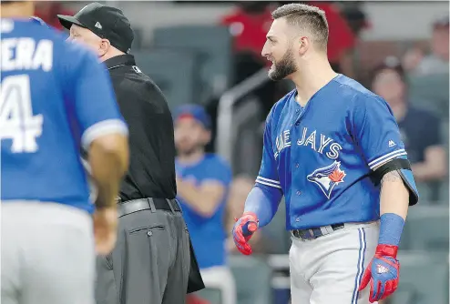  ?? JOHN BAZEMORE / THE ASSOCIATED PRESS ?? Kevin Pillar, right, looks on as both benches empty onto the field after he directed an anti-gay slur in the direction of Braves pitcher Jason Motte in Wednesday’s game in Atlanta. Pillar was given a two-game suspension by the Jays.