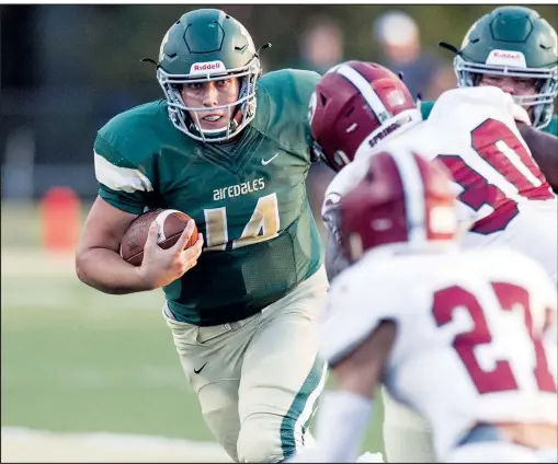  ?? File photo/NWA Democrat-Gazette/BEN GOFF • @NWABENGOFF ?? Landon Blair (14), Alma quarterbac­k, runs the ball against Springdale on Sept. 13 at Airedale Stadium in Alma. The Airedales, the No. 3 seed from the 5A-West Conference, will travel to Forest City on Friday for a first-round playoff game.