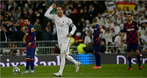  ?? AP Photo/Andrea Comas ?? Real Madrid’s Sergio Ramos celebrates as he runs past Barcelona’s Lionel Messi during the Spanish La Liga soccer match between Real Madrid and Barcelona at the Santiago Bernabeu stadium in Madrid, Spain, on Sunday.