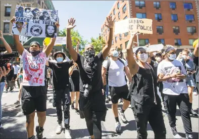  ?? Mary Altaffer / Associated Press ?? Protesters march through the streets of Harlem during a solidarity rally for George Floyd on Saturday in New York. Floyd died after Minneapoli­s police officer Derek Chauvin pressed his knee into his neck for several minutes even after he stopped moving and pleading for air.