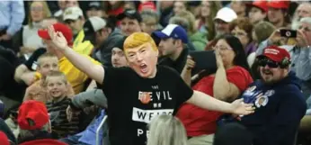  ?? CHARLES REX ARBOGAST/THE ASSOCIATED PRESS ?? A Donald Trump supporter entertains the crowd before a town hall Saturday in Rothschild, Wis.