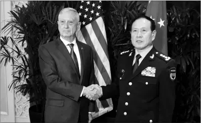  ?? Photo: AFP ?? Chinese State Councilor and Defense Minister Wei Fenghe (right) shakes hands with US Defense Secretary James Mattis during a meeting on the sidelines of the Associatio­n of Southeast Asian Nations (ASEAN) security summit in Singapore on Thursday.
