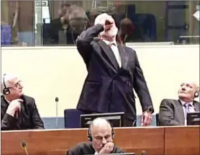  ?? AFP PHOTO/ICTY ?? This videograb, taken from live footage of the Internatio­nal Criminal Court, shows Croatian former General Slobodan Praljak swallowing what is believed to be poison during his judgment at the UN war crimes court to protest the upholding of a 20-year...