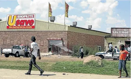  ?? / MOHAU MOFOKENG ?? Retail grocery stores have gone into the townships to bring business nearer to the locals, a move that is seen as harmful by other trading groups.