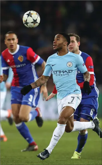  ??  ?? Raheem Sterling of Manchester City keeps his eyes on the ball during their hammering of Basel.