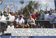  ??  ?? 2020 Australian Open Doubles winners and 2019 Champions, Joe Salisbury and Rajeev Ram with the children from the JP Morgan Kids’ Day clinic.