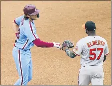  ?? MATT SLOCUM — THE ASSOCIATED PRESS ?? Baltimore second baseman Hanser Alberto, right, greets the Phillies’ Alec Bohm after Bohm hit a double in his first at-bat on Thursday at Citizens Bank Park.