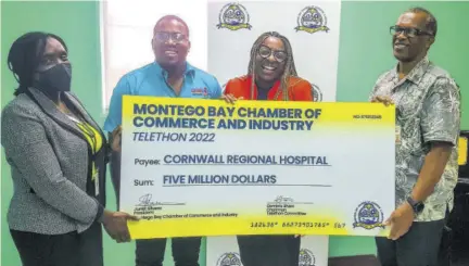  ?? (Photo: Anthony Lewis) ?? Telethon committee chairman, Dominic Shaw (second left) and president of the MBCCI Janet Silvera (second right) present a symbolic cheque to CRH’S Chief Executive Officer Charmaine Williams Beckford (left) and the hospital’s SMO, Dr Derek Harvey.