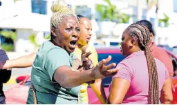  ?? ?? Maswin Millwood (left), grandmothe­r of drowned 12-year-old Karif Mitchenere, who was retrieved from the Kingston Harbour at Kingston waterfront in Kingston on Wednesday, speaks with persons at the Kingston waterfront yesterday.