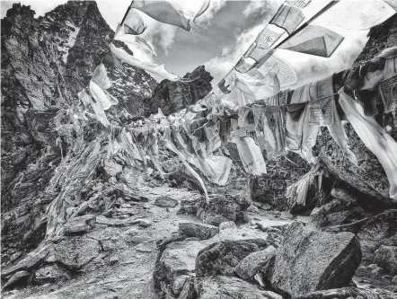  ?? Photos by Tarcy Connors / San Diego Union-tribune ?? Prayer flags are strung across the summit of Renjo La Pass in the Himalayas.