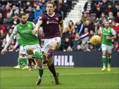  ??  ?? Christophe Berra is powerless to stop Martin Boyle scoring the first for Hibs at Tynecastle