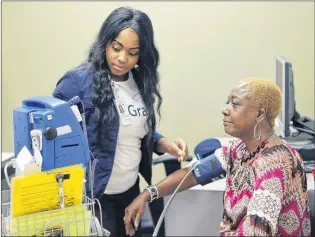  ?? BOBANDRES / AJC ?? Lynette McClain of Atlanta gets her blood pressure checked Friday by Marie Carter ataGrady Primary Care Clinic. The Medicare patient said she is opposed to repealing or replacing Obamacare. Other Georgians were disappoint­ed that the U.S. Senate was...