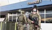  ?? GARY RAMAGE AP ?? Australian soldiers stand outside the airport in Honiara, Solomon Islands, on Saturday. Violence receded in the capital of the Solomon Islands, but the government showed no signs of attempting to address the underlying grievances that sparked two days of riots.