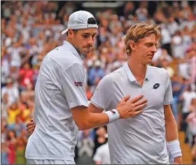  ?? Associated Press ?? Wimbledon classic: Kevin Anderson of South Africa, right, meets John Isner of the U.S. on the court after defeating him in their men's singles semifinal match at the Wimbledon Tennis Championsh­ips in London Friday.