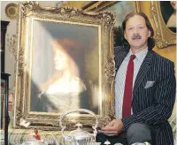  ??  ?? Lunds’ president Peter Boyle holds a painting titled Red Hair Beauty and signed by Harlamoff. Alexei Harlamoff was a Russian painter who died in the 1920s.