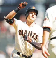  ?? Scott Strazzante / The Chronicle ?? San Francisco Giants’ Mike Yastrzemsk­i high-fives Ron Wotus after his 4th-inning home run against Colorado Rockies at Oracle Park in San Francisco, Calif., on Sept. 26. Yastrzemsk­i, who spent six full seasons in the minors and 40 games last year before his promotion by San Francisco, said: “I think for a long time we’ve had this idea in baseball that you have to put in your time. To an extent that may be true, but we need to make sure that everybody has an opportunit­y to make themselves better.”